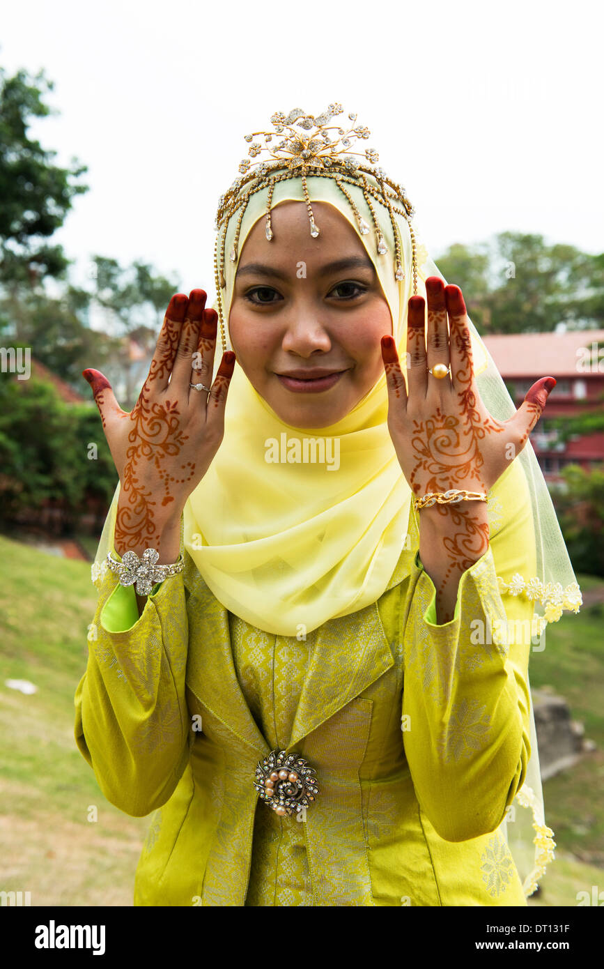A newlywed Malay couple dressed in traditional Malacca royalty clothing. Stock Photo