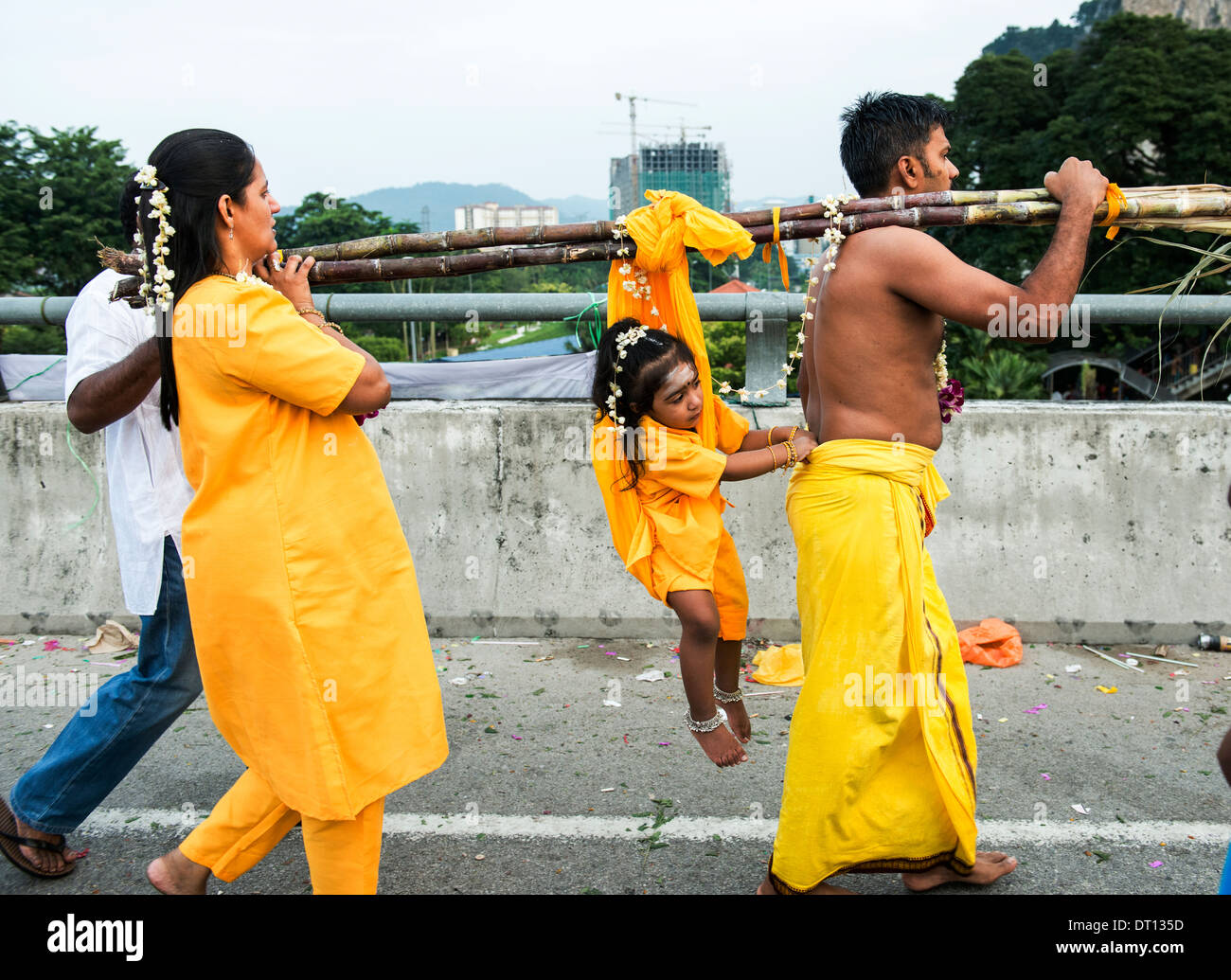 A couple carrying their girl to Batu caves during the Hindu festival of Thaipusam. Stock Photo