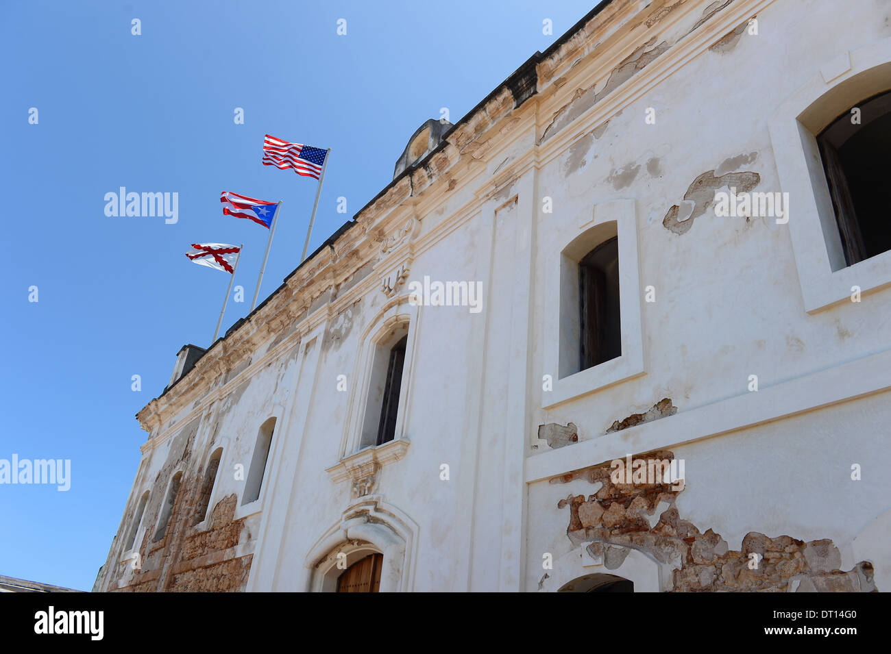 Flags atop building in Castillo San Cristobal, San Juan Puerto Rico Stock Photo