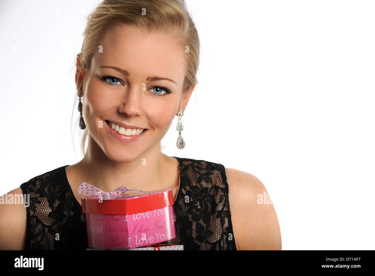 Portrait of young woman holding valentine gifts isolated over white background Stock Photo