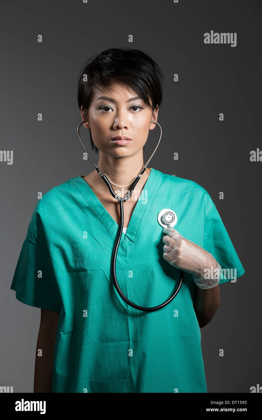 Chinese Female Doctor in surgical scrubs with stethoscope around neck Stock Photo