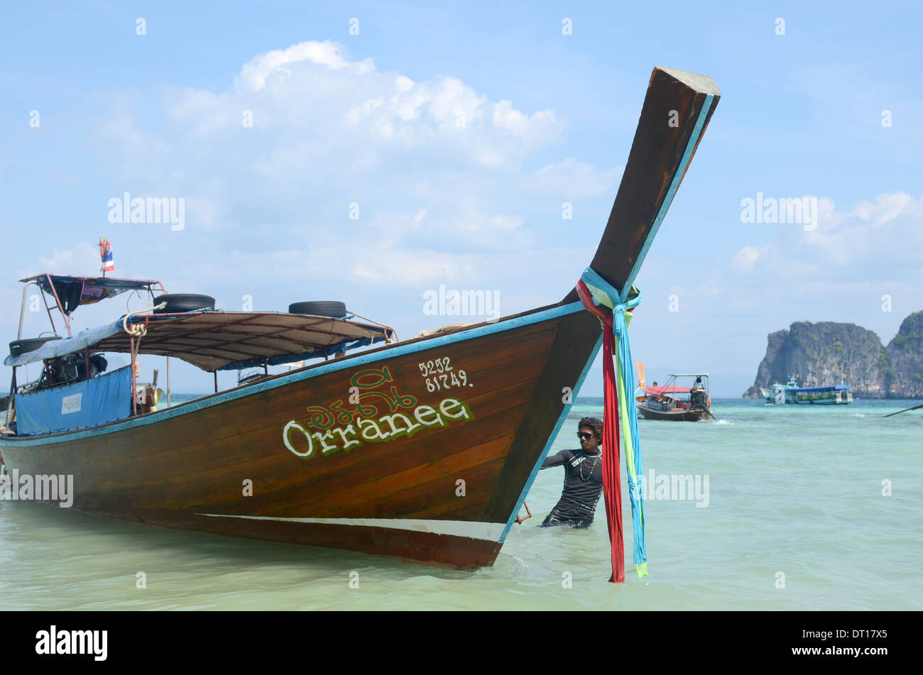 Tour guide with longtail boat in sea, Koh Ngai, Koh Lanta, Thailand Stock Photo