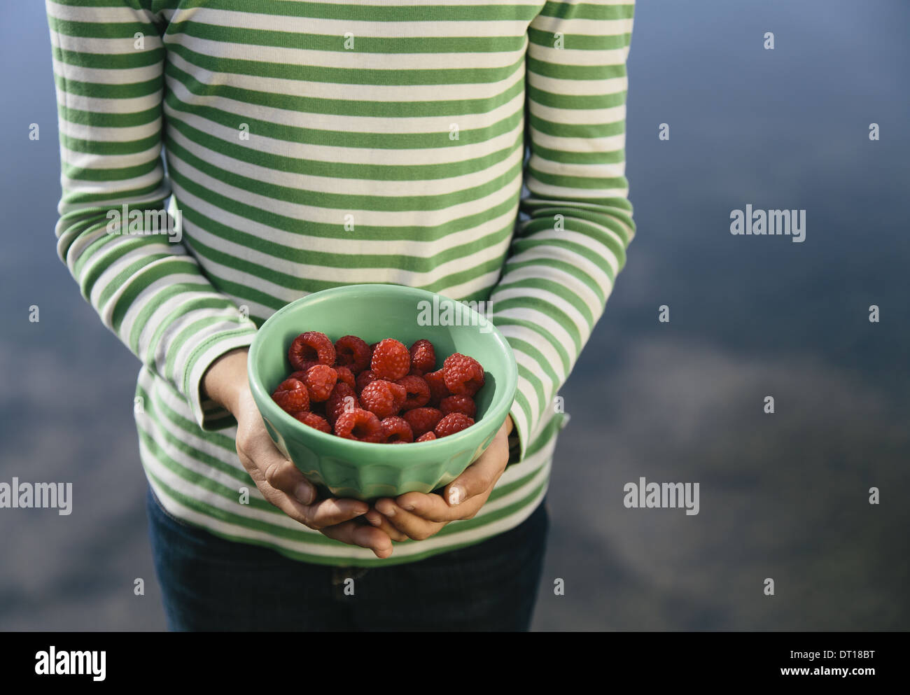 Seattle Washington USA Nine year old girl bowl of organic raspberries Stock Photo
