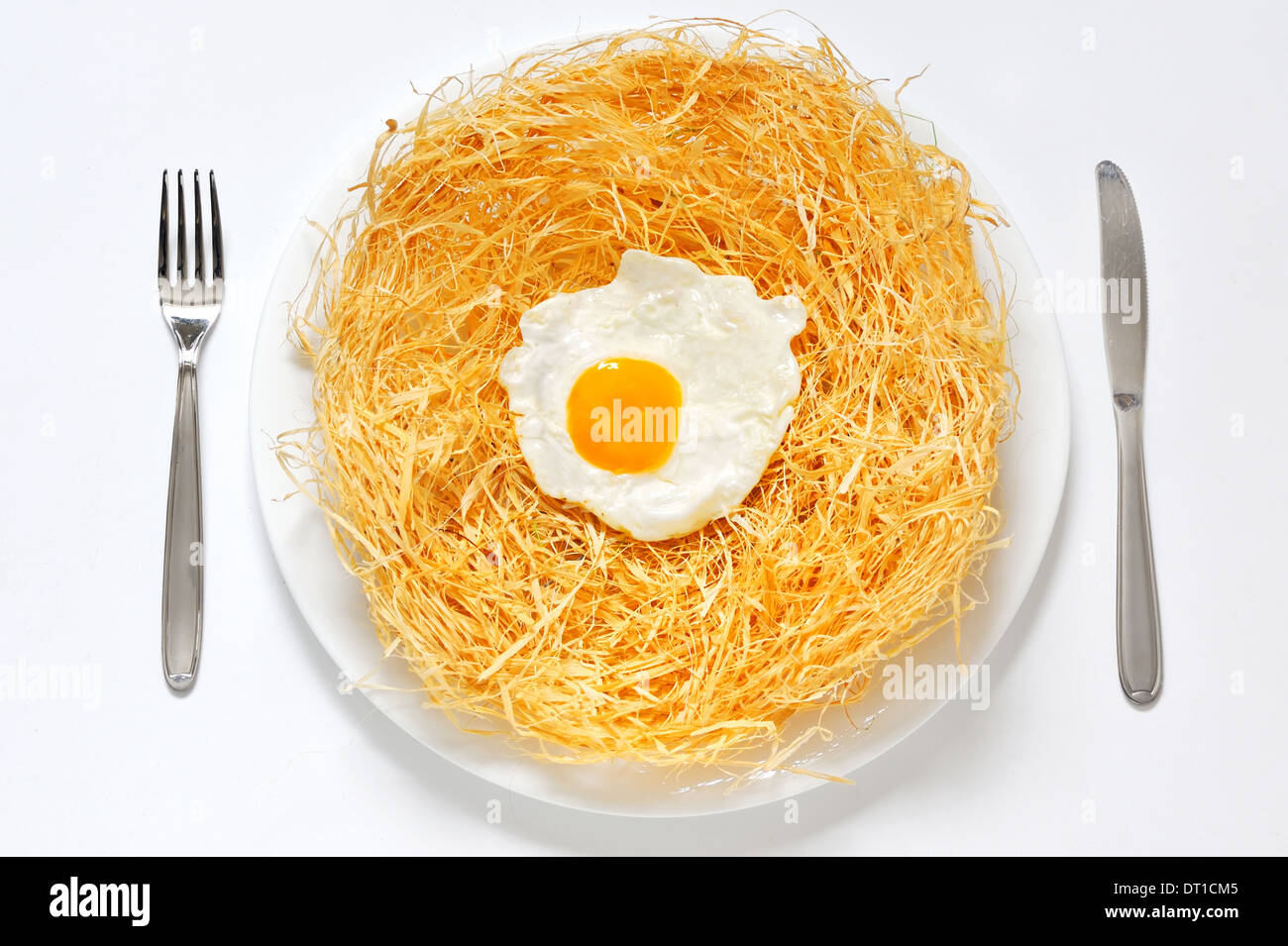 organic fried eggs in the straw on white background Stock Photo - Alamy