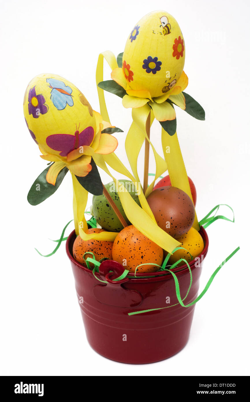 Red bucket with painted easter eggs on a white background. Stock Photo