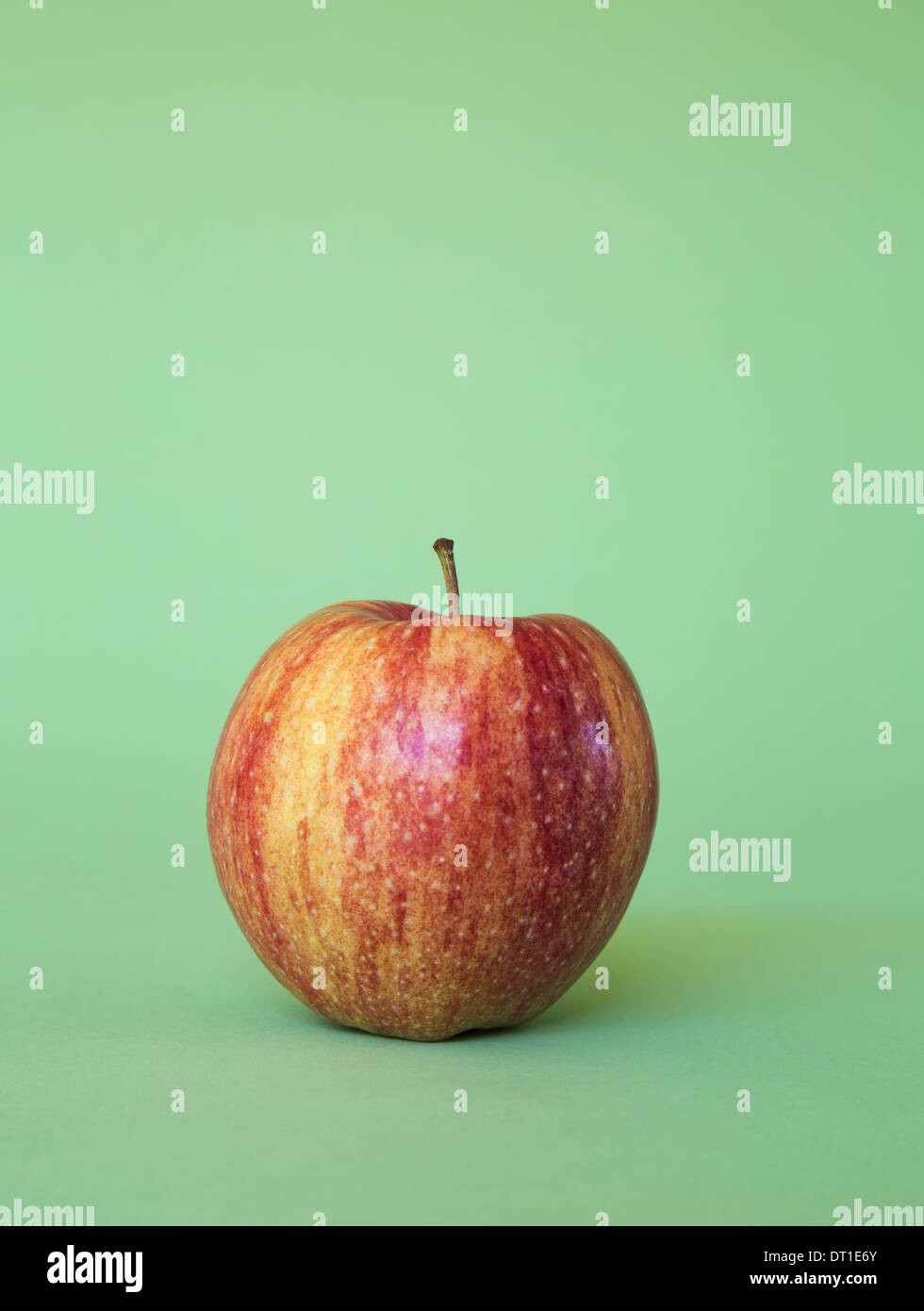 Honey Crisp apple on green background Stock Photo