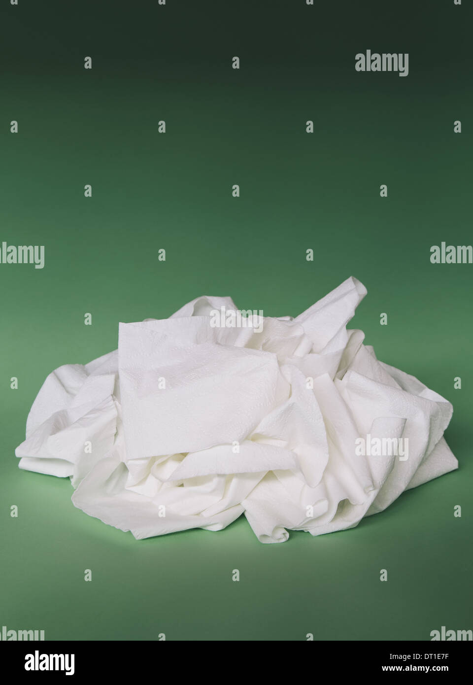 unwound toilet paper in heap on green background Stock Photo Alamy