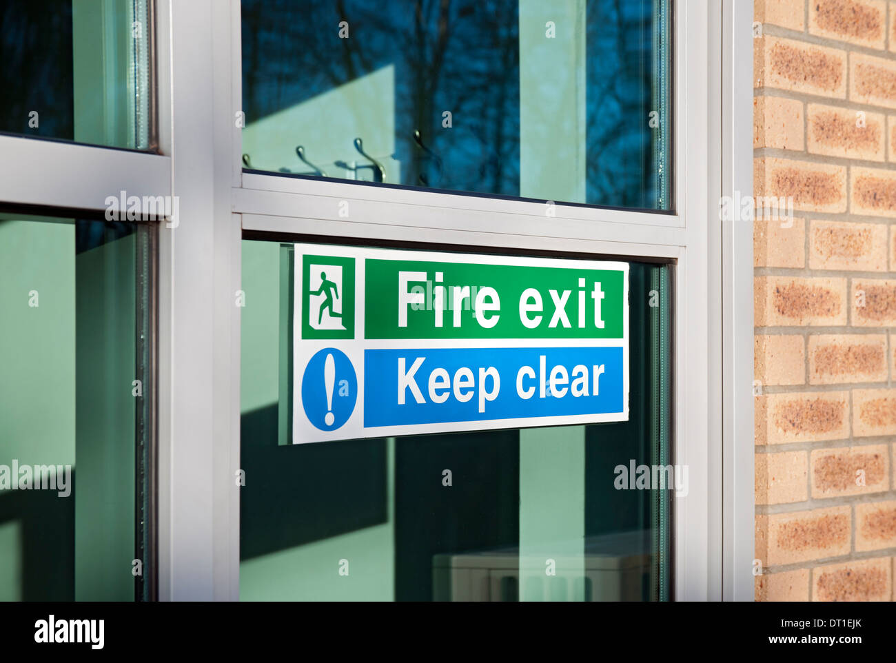 Close up of Fire exit and keep clear sign signs on glass door England UK United Kingdom GB Great Britain Stock Photo