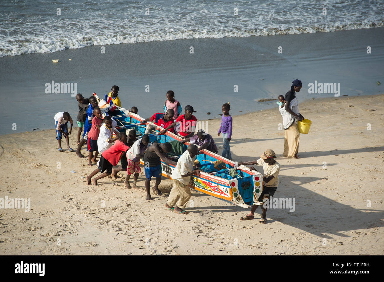 Men pulling in a fishing pirogue, Bakau, Banjul, the Gambia Stock Photo ...