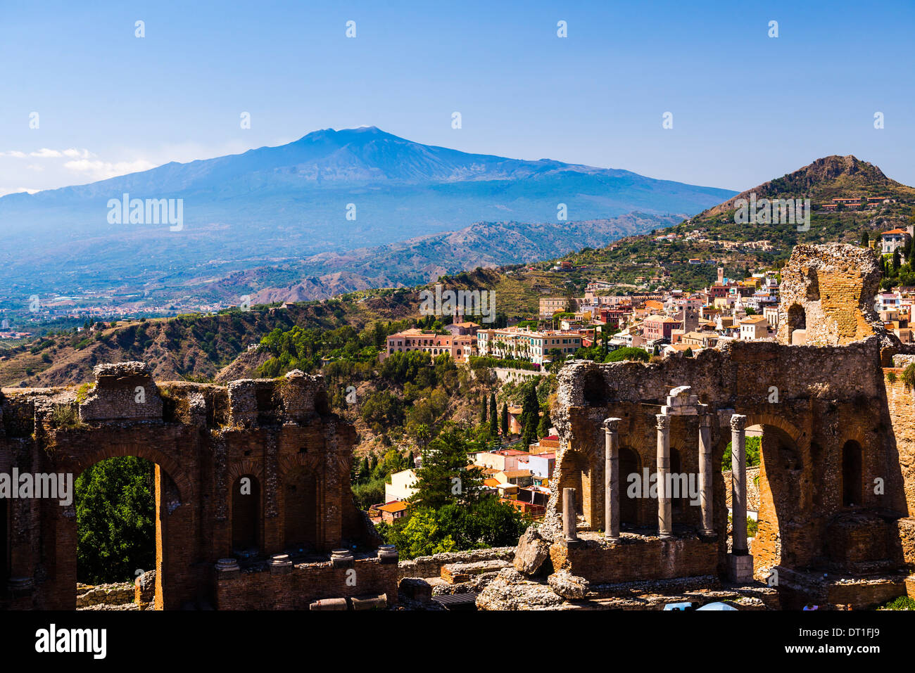 Mount Etna Volcano with ruins of Teatro Greco (Greek Theatre) in the foreground, Taormina, Sicily, Italy, Europe Stock Photo