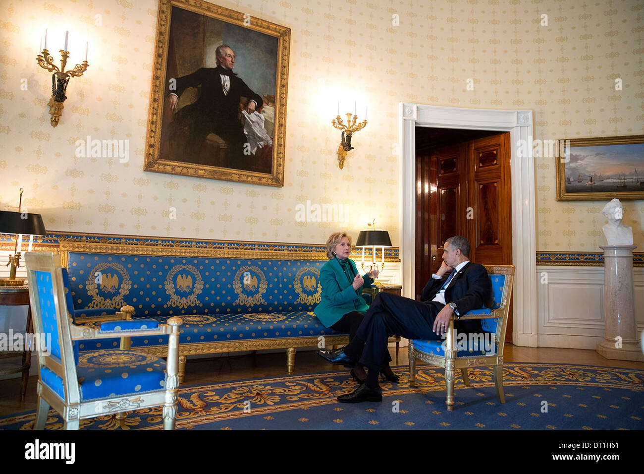 US President Barack Obama talks with former Secretary of State Hillary Rodham Clinton in the Blue Room of the White House following the 2013 Presidential Medal of Freedom ceremony November 20, 2013 in Washington, DC. Stock Photo
