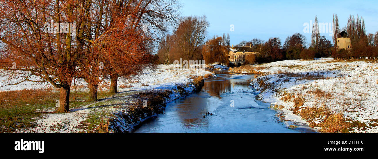 A frosty, snowy winter scene over the river Nene at Castor village, Cambridgeshire, England; Britain; UK Stock Photo