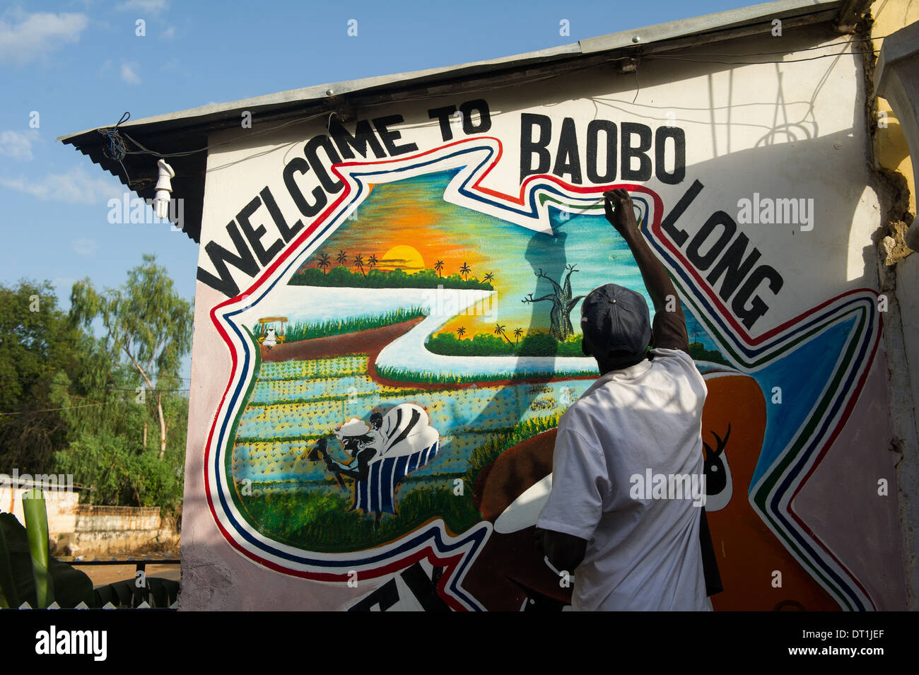 Artist painting a mural, Janjangbureh, the Gambia Stock Photo