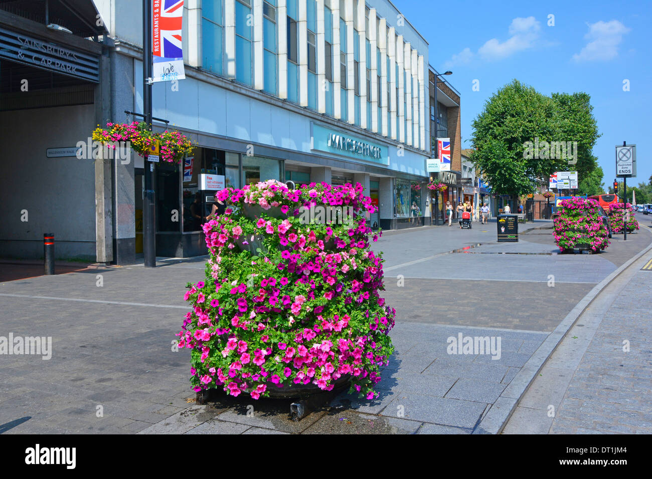 Flower displays after early morning watering outside Marks and Spencers