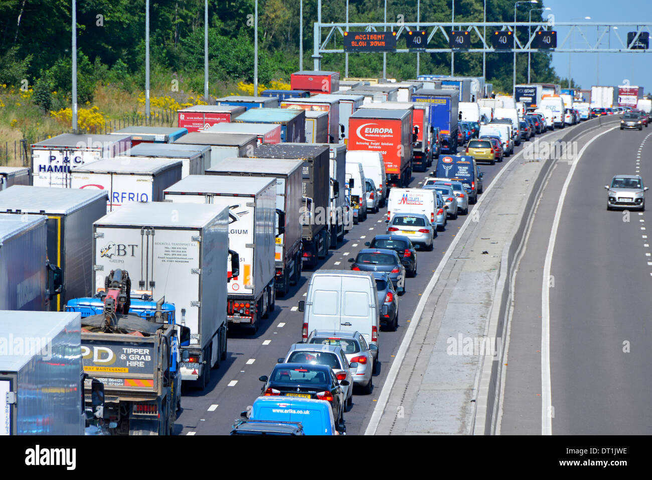 Four lane M25 motorway and gridlocked (mainly) trucks with articulated trailers stuck in queue because of an accident Stock Photo