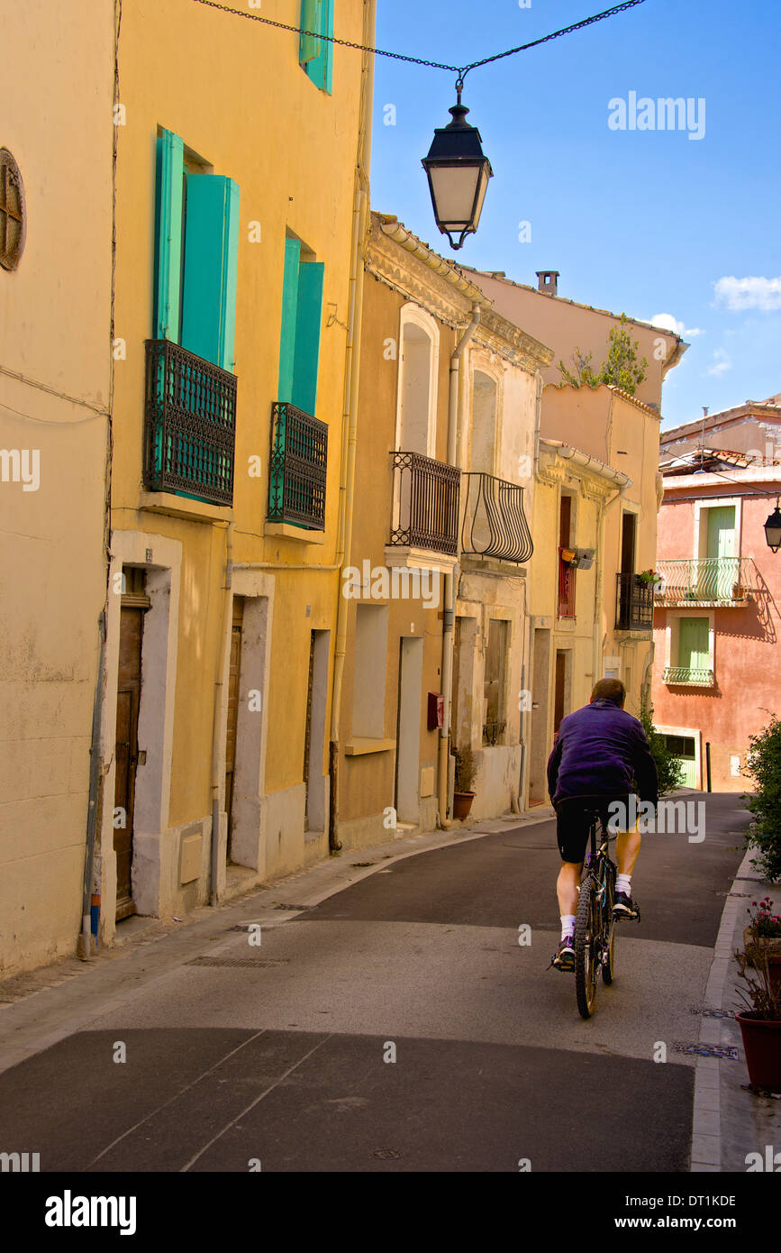 Street with cyclist, Old town, Bouzigues, Thau basin, Herault, Languedoc, France, Europe Stock Photo