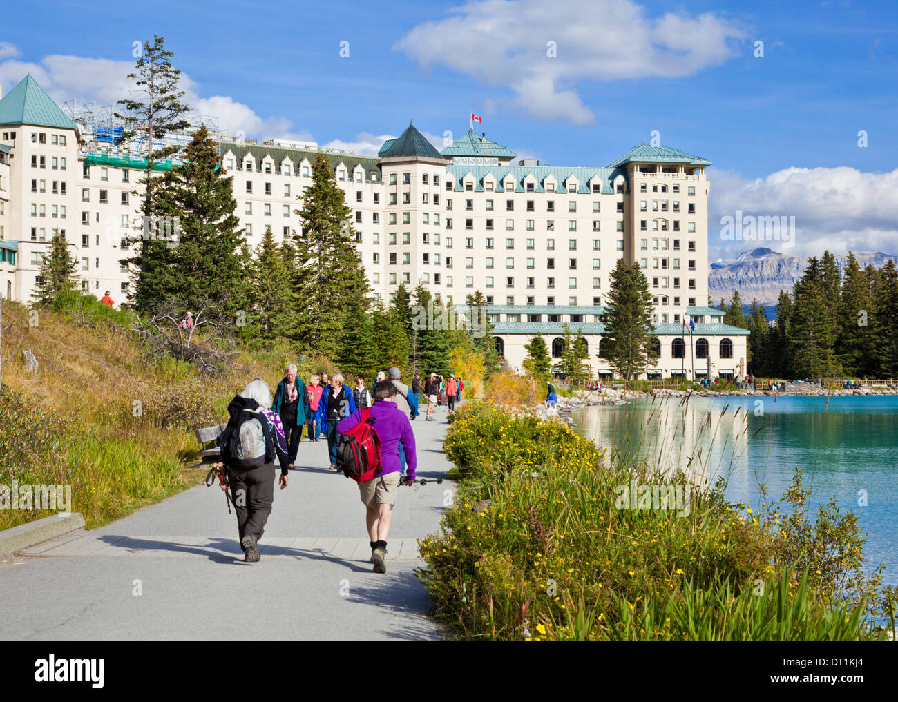 Hikers walking towards The Fairmont Chateau Lake Louise Hotel, Banff ...