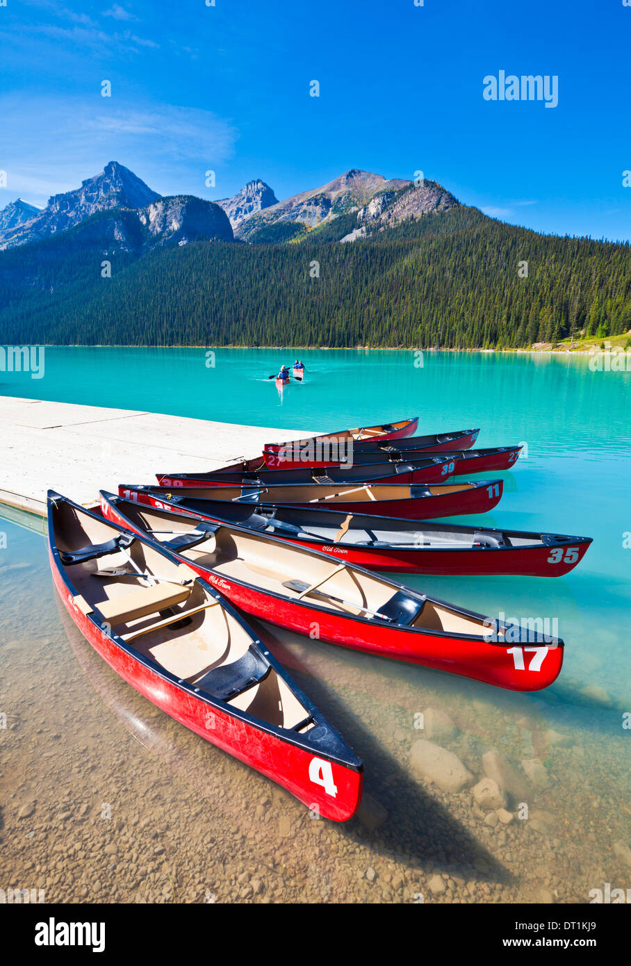 Red canoes for hire on Lake Louise, Banff National Park, UNESCO World Heritage Site, Alberta, The Rockies, Canada, North America Stock Photo