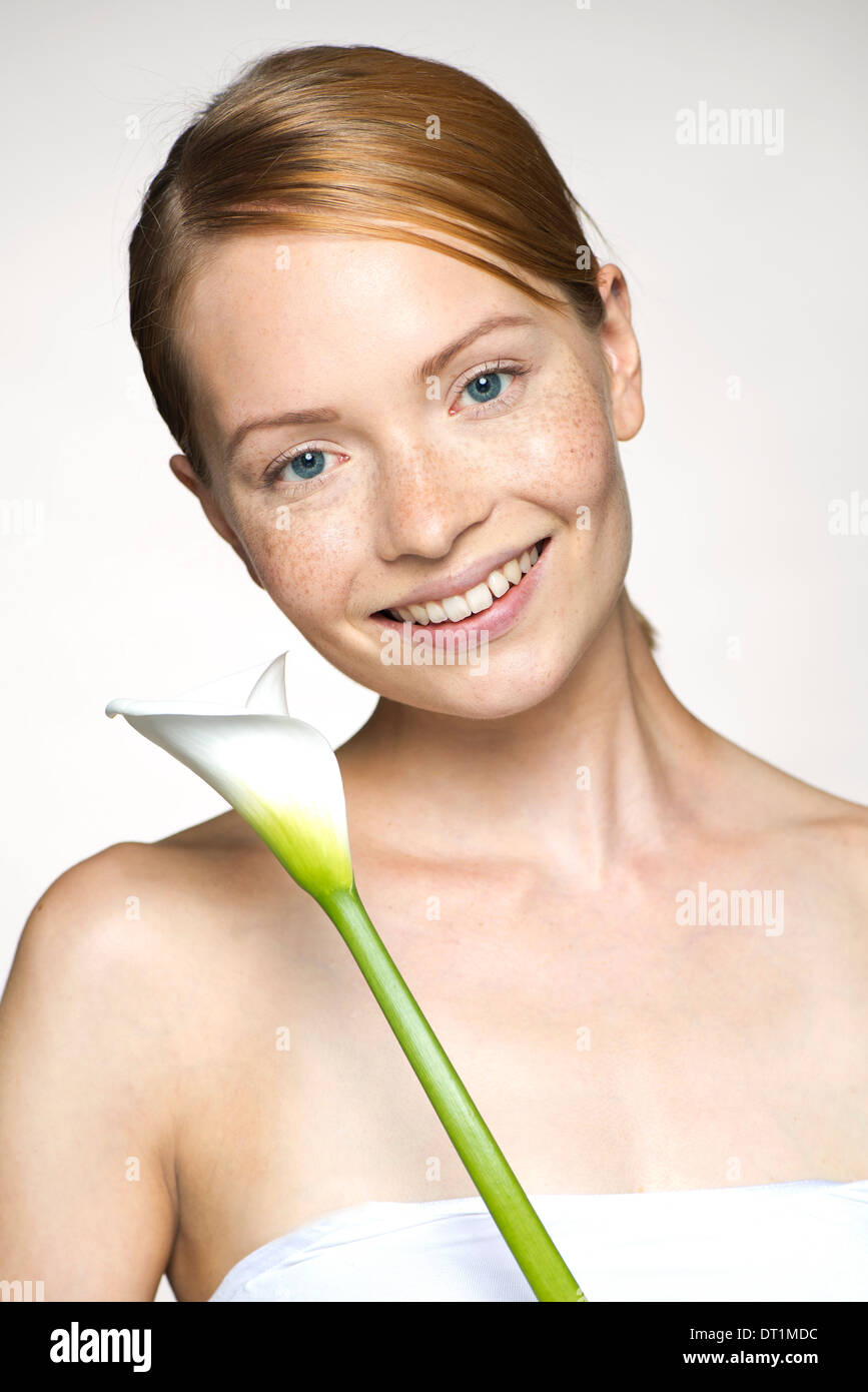 Young woman with calla lily, portrait Stock Photo
