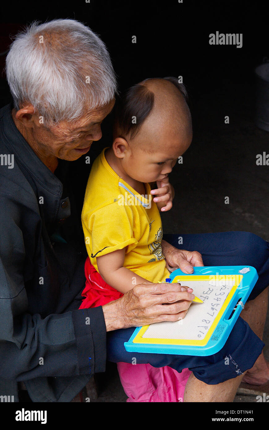 Grandfather and  child, Dong village of Zhaoxing, Guizhou Province, China, Asia Stock Photo