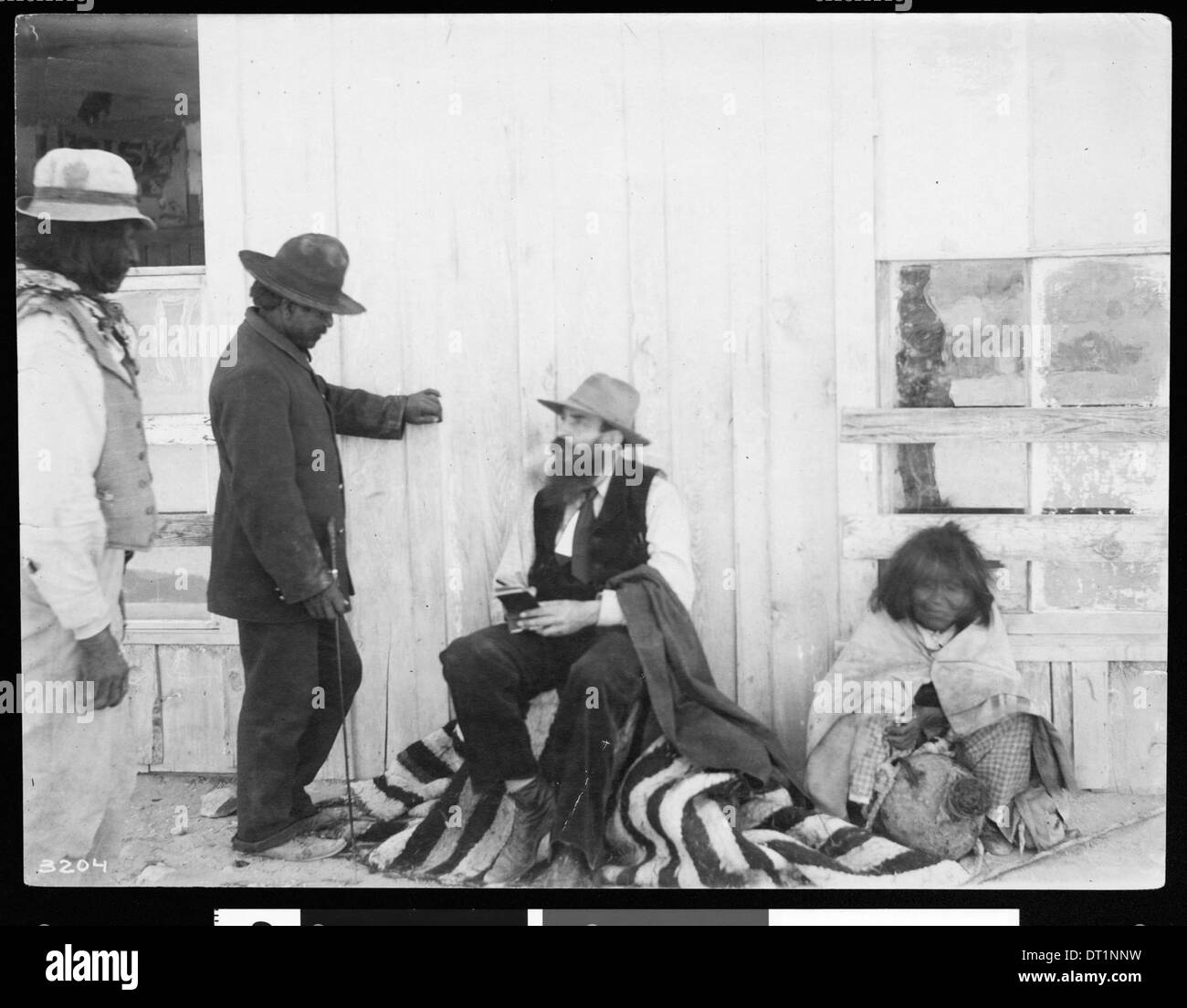 Wharton James taking notes in a small notebook, Kingman, Arizona
