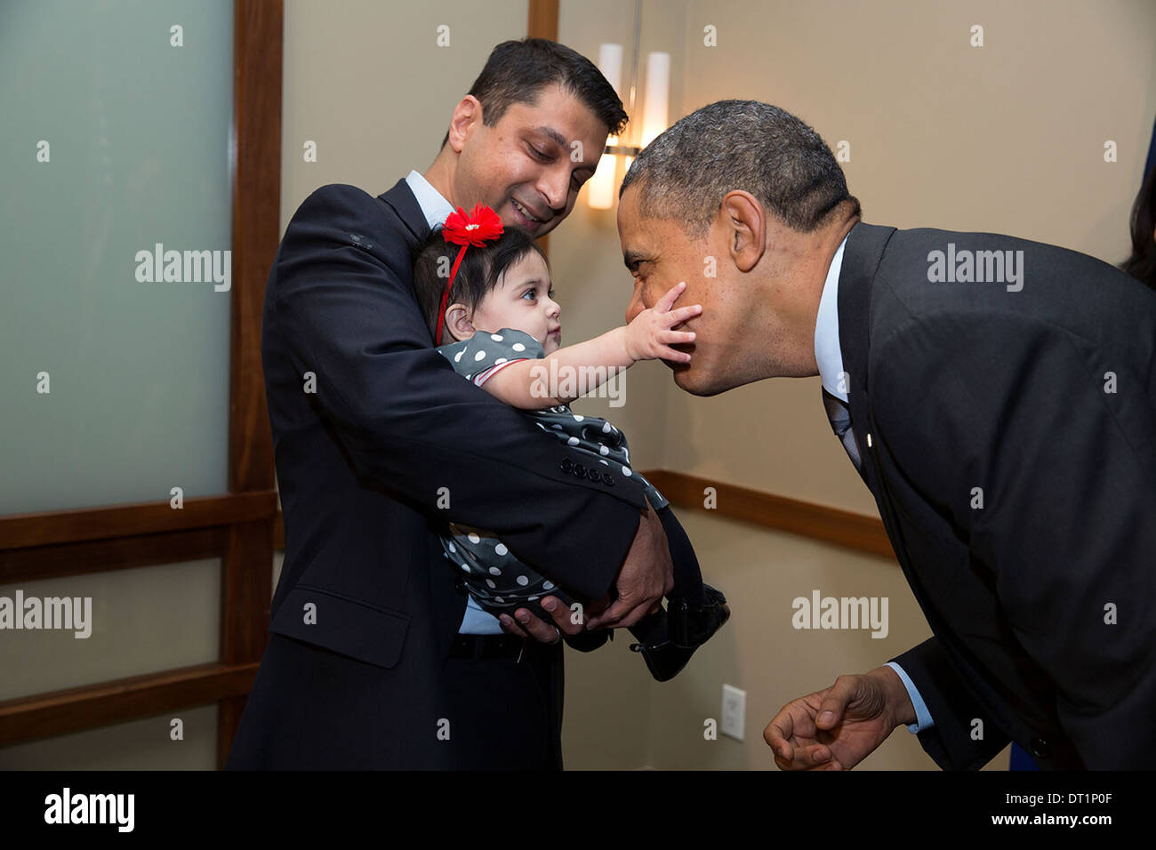 US President Barack Obama plays with a baby November 26, 2013 in Beverly Hills, CA. Stock Photo