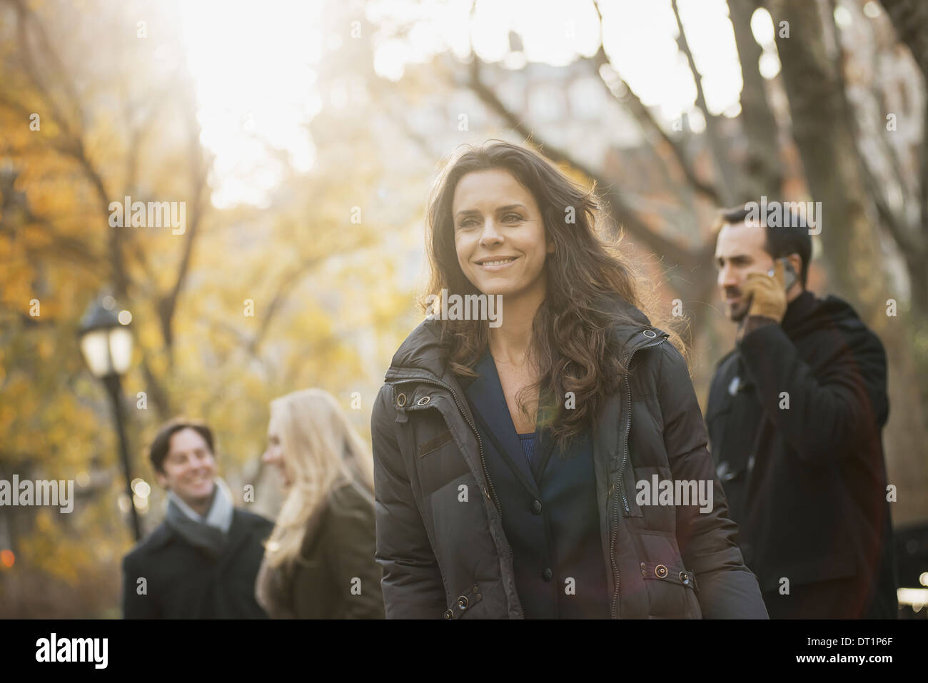 Adult group in urban park woman in front Stock Photo