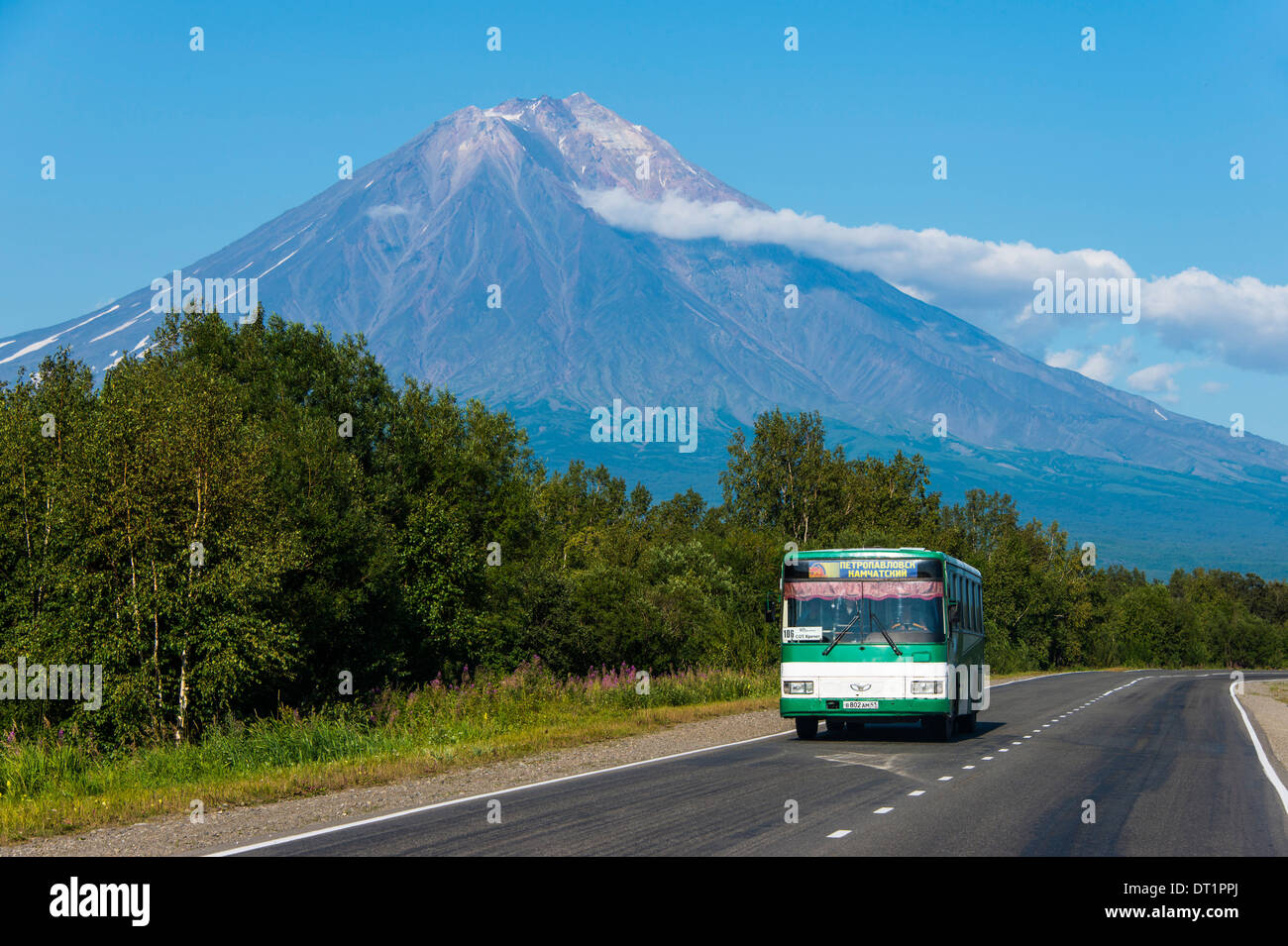 Public bus in front of the Avachinskaya Sopka volcano near Petropavlovsk-Kamchatsky, Kamchatka, Russia, Eurasia Stock Photo