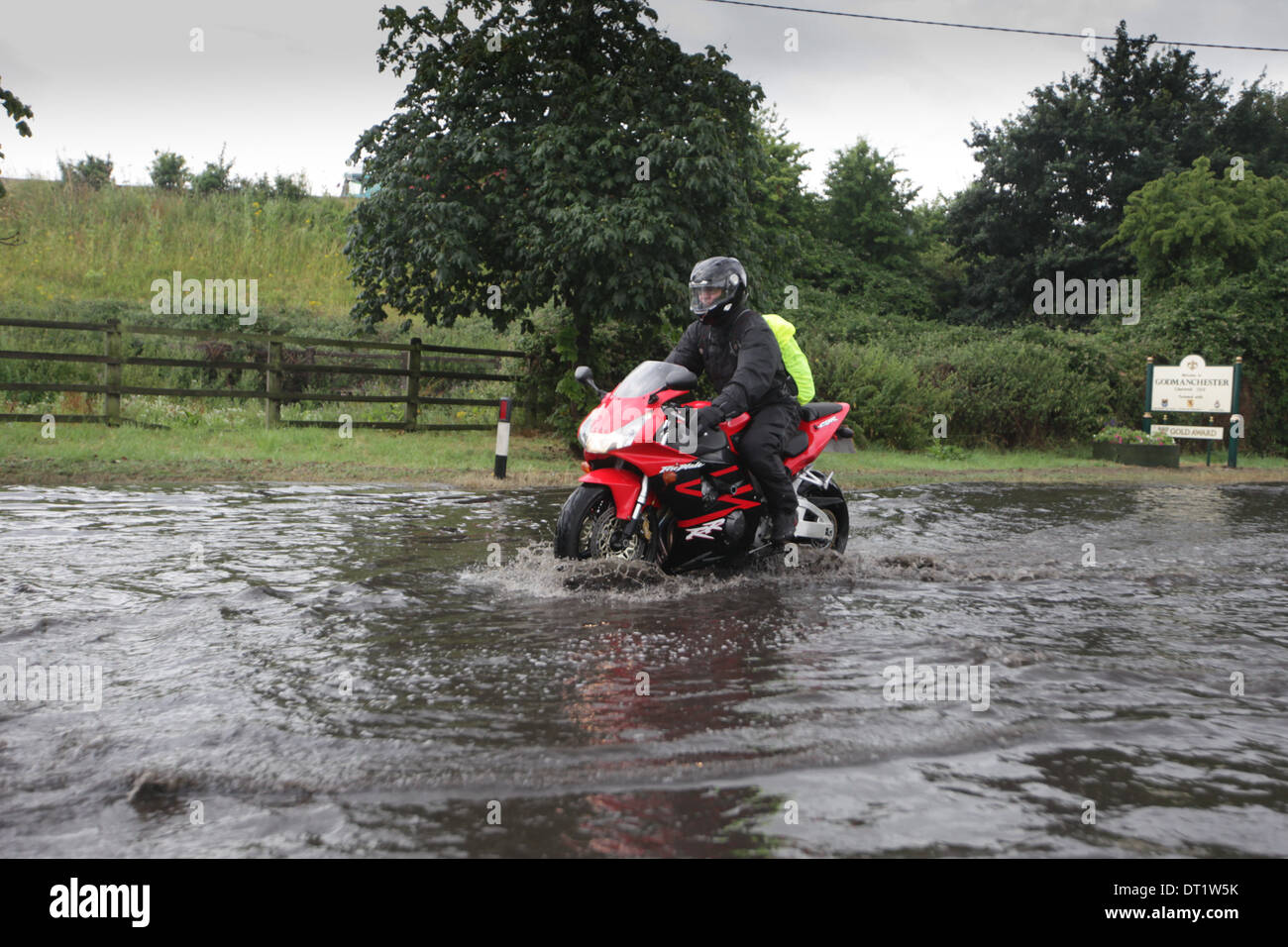 MOTORBIKE  DRIVING THROUGH FLOOD WATER IN HUNTINGDON,CAMBRIDGESHIRE. Stock Photo