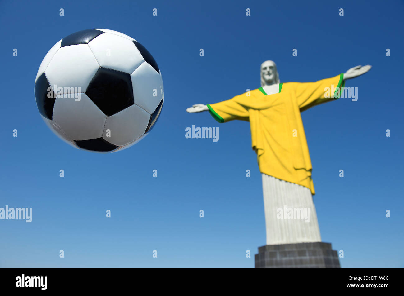 Christ the Redeemer wearing Brazil colors soccer uniform with football at Corcovado Rio de Janeiro Stock Photo
