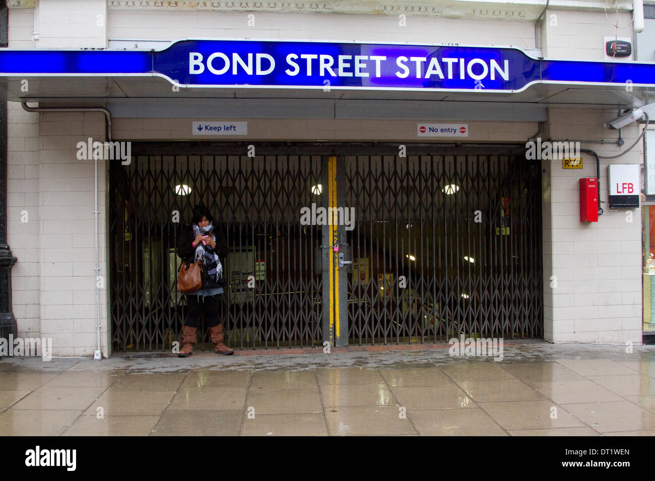 London UK. 6th February 2014. A member of the public stands outside a closed Bond Street Underground station on Day 2 of the 48 hour tube strike called by the RMT union to protest against plans to close ticket office which would result in compulsory staff redundancies Credit:  amer ghazzal/Alamy Live News Stock Photo