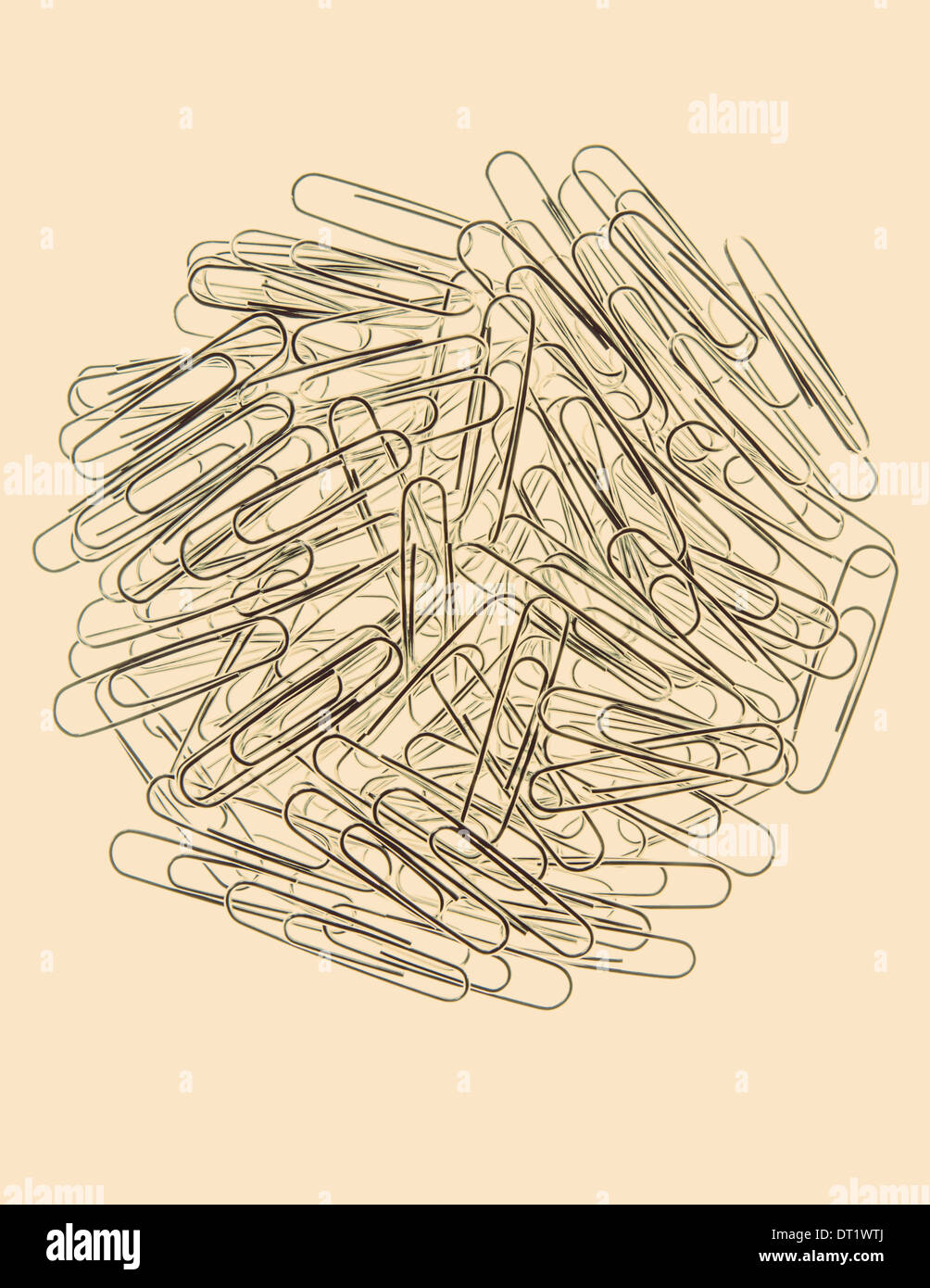 A large group of metal paperclips on a pale background Stock Photo