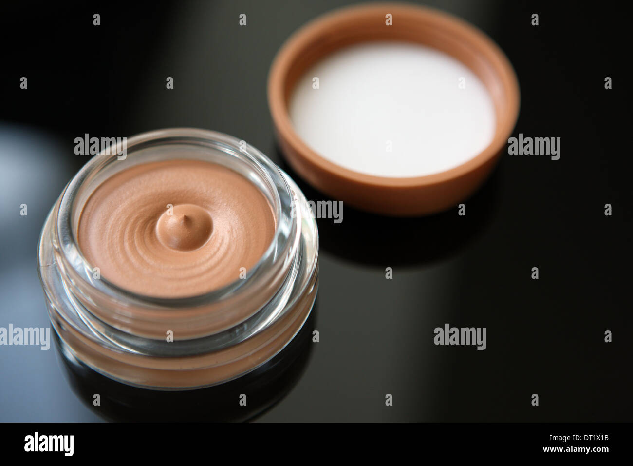 Foundation make-up in a glass jar Stock Photo