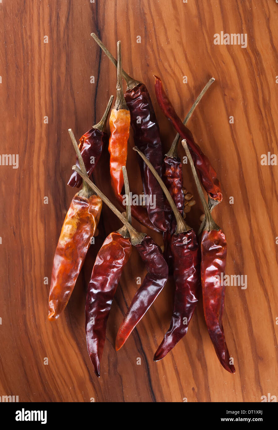 Dried red chili peppers n the olive wood desk Stock Photo - Alamy