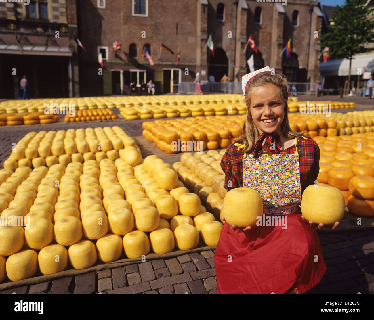 Holland, Alkmaar Cheese Market, a smiling blonde Dutch salesgirl in ...