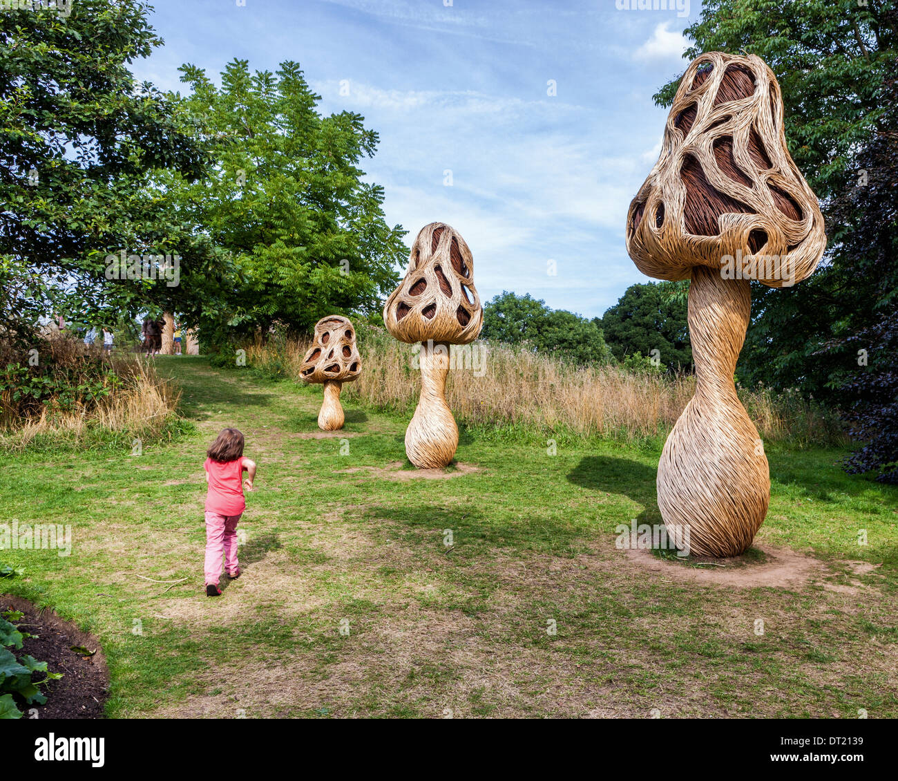 Young child and Mushrooms in a Fungi Fairy Ring by Tom Hare at IncrEdibles Festival at Royal Botanic Garden, Kew Gardens,  UK Stock Photo