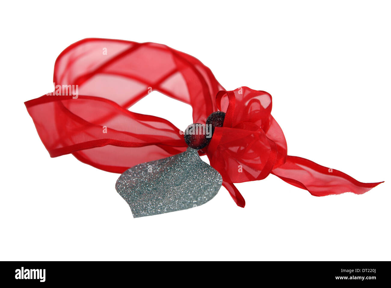 Red ribbon with gift tag and berries on a white background Stock Photo