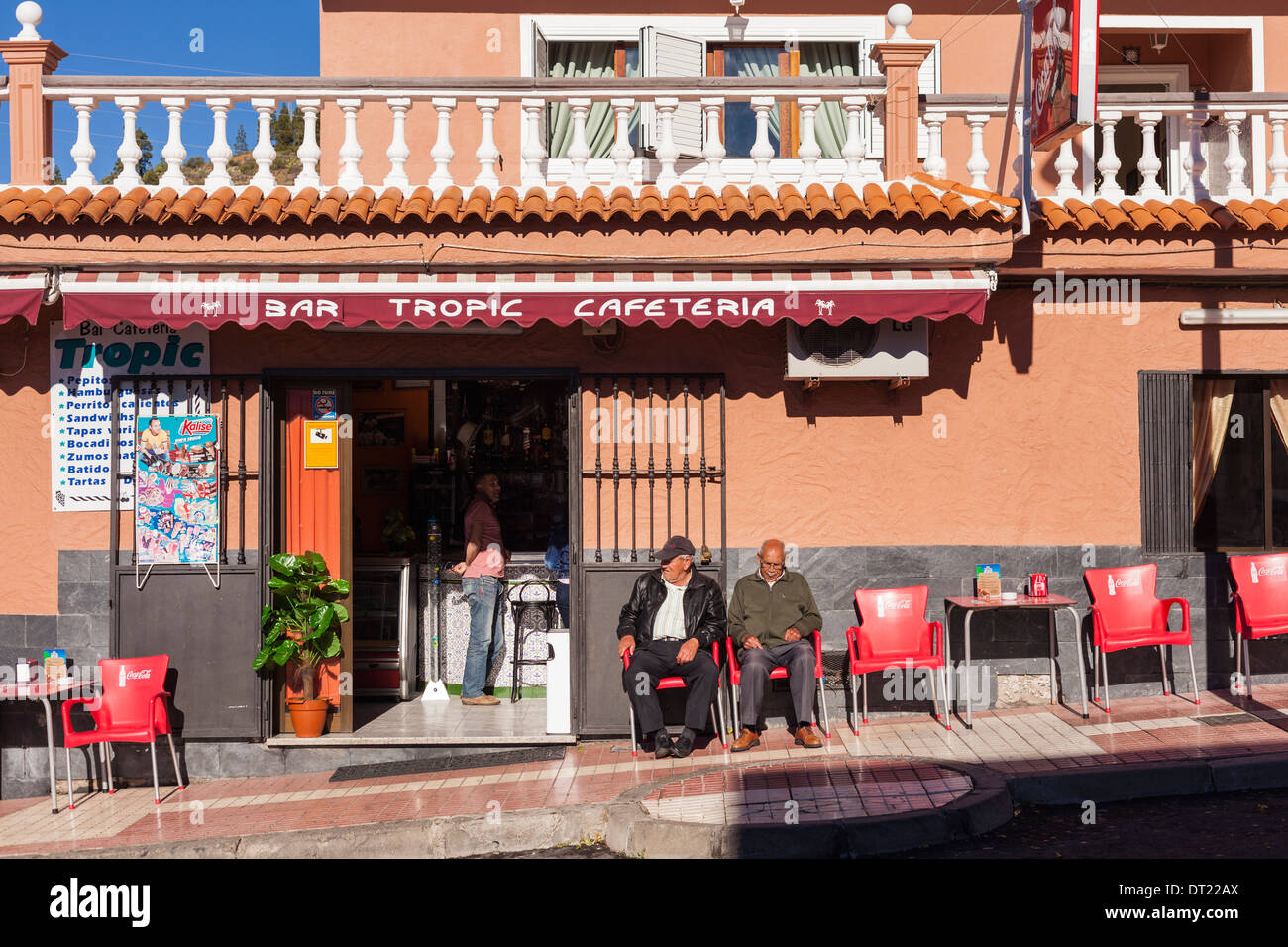 Elderly men sitting in the sun outside a bar in Arguayo, Tenerife, Canary Islands, Spain. Stock Photo
