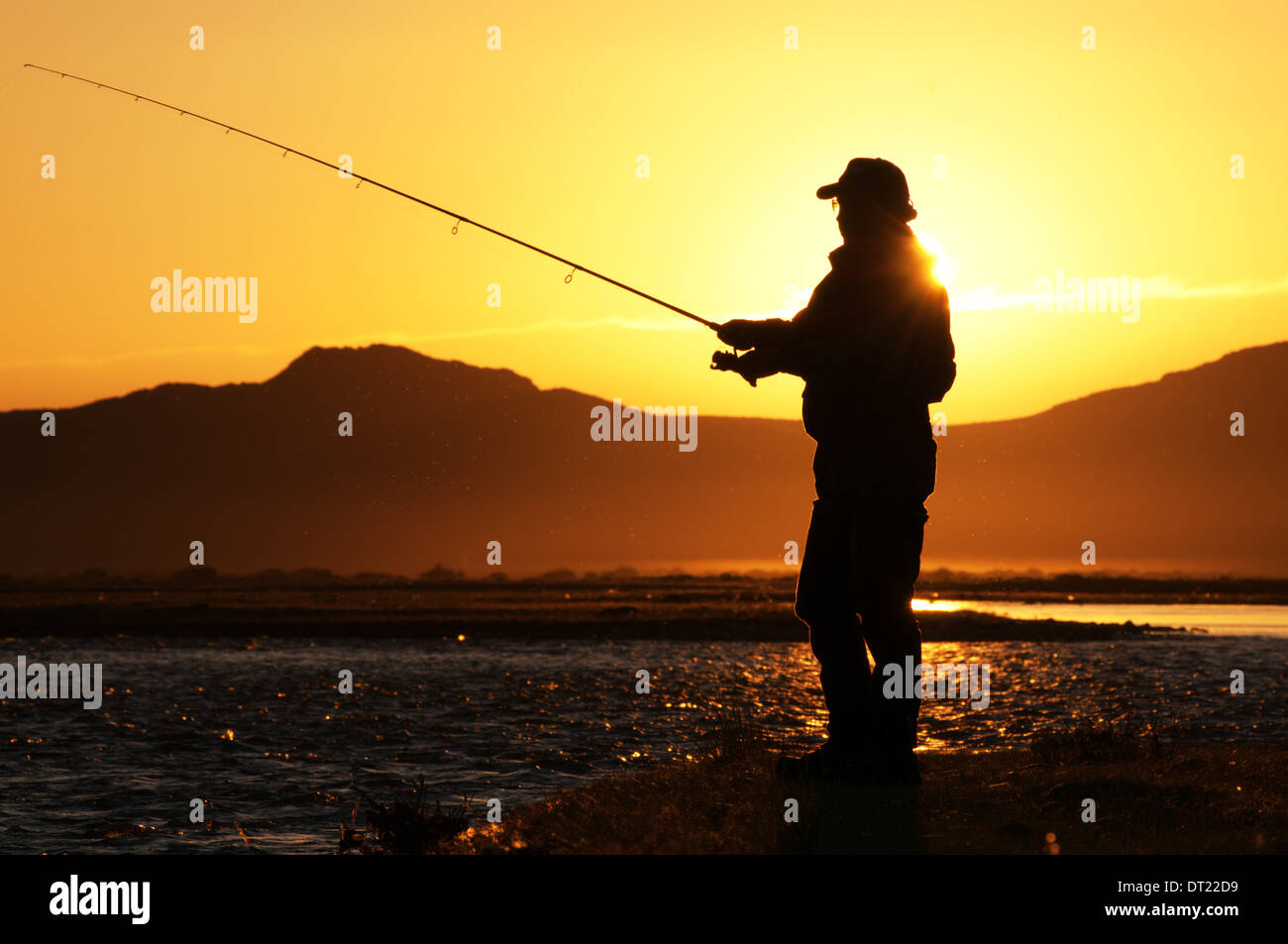 Fisherman silhouette at sunrise Stock Photo - Alamy