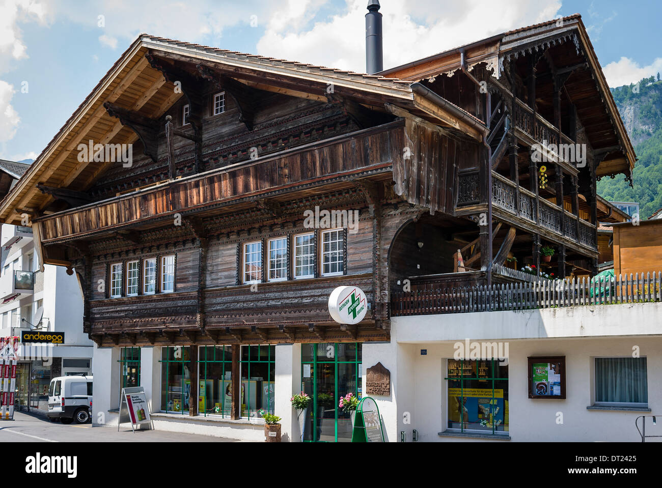 Wooden building and railway station at rear in Brienz serving the Rothorn trains Stock Photo