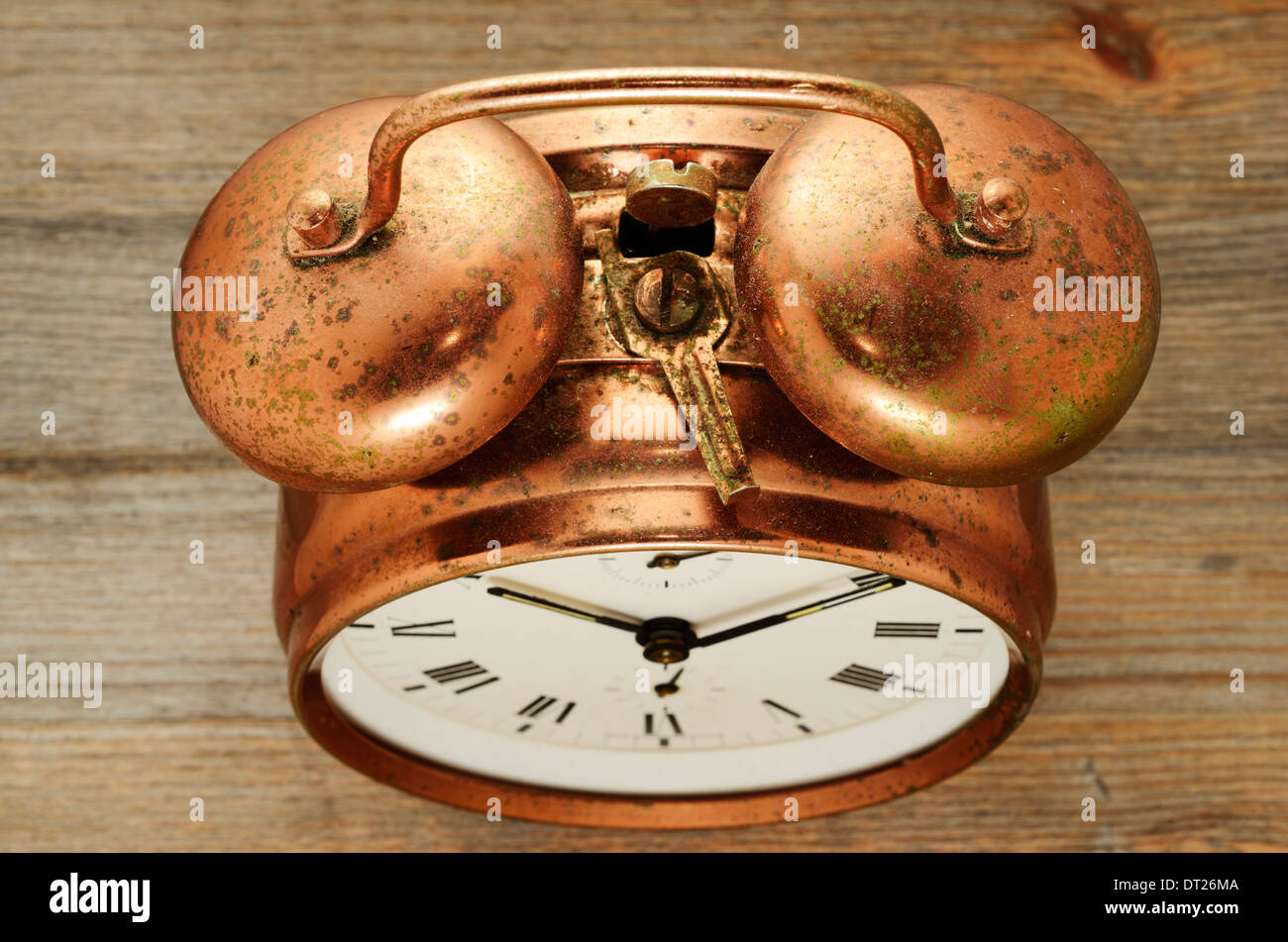 old-fashioned vintage copper alarm clock on wooden background Stock ...