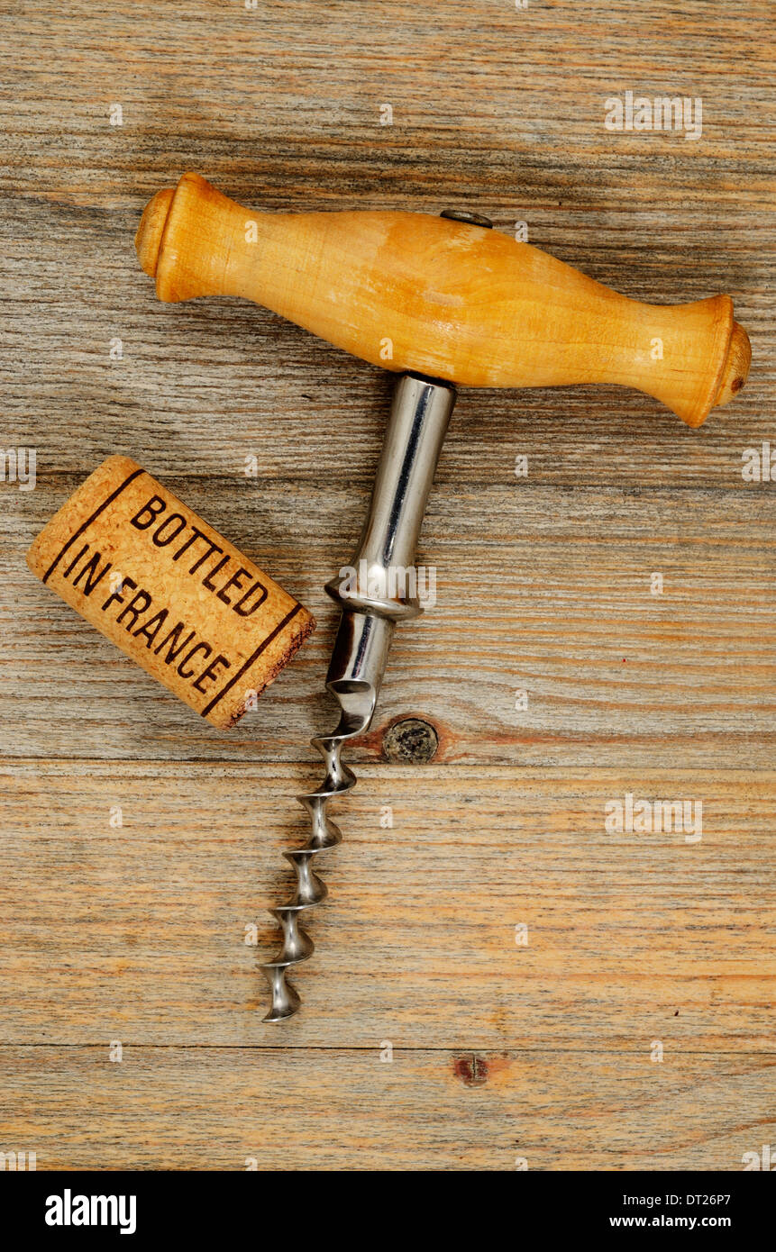 vintage old corkscrew and wine cork with inscription bottled in France Stock Photo