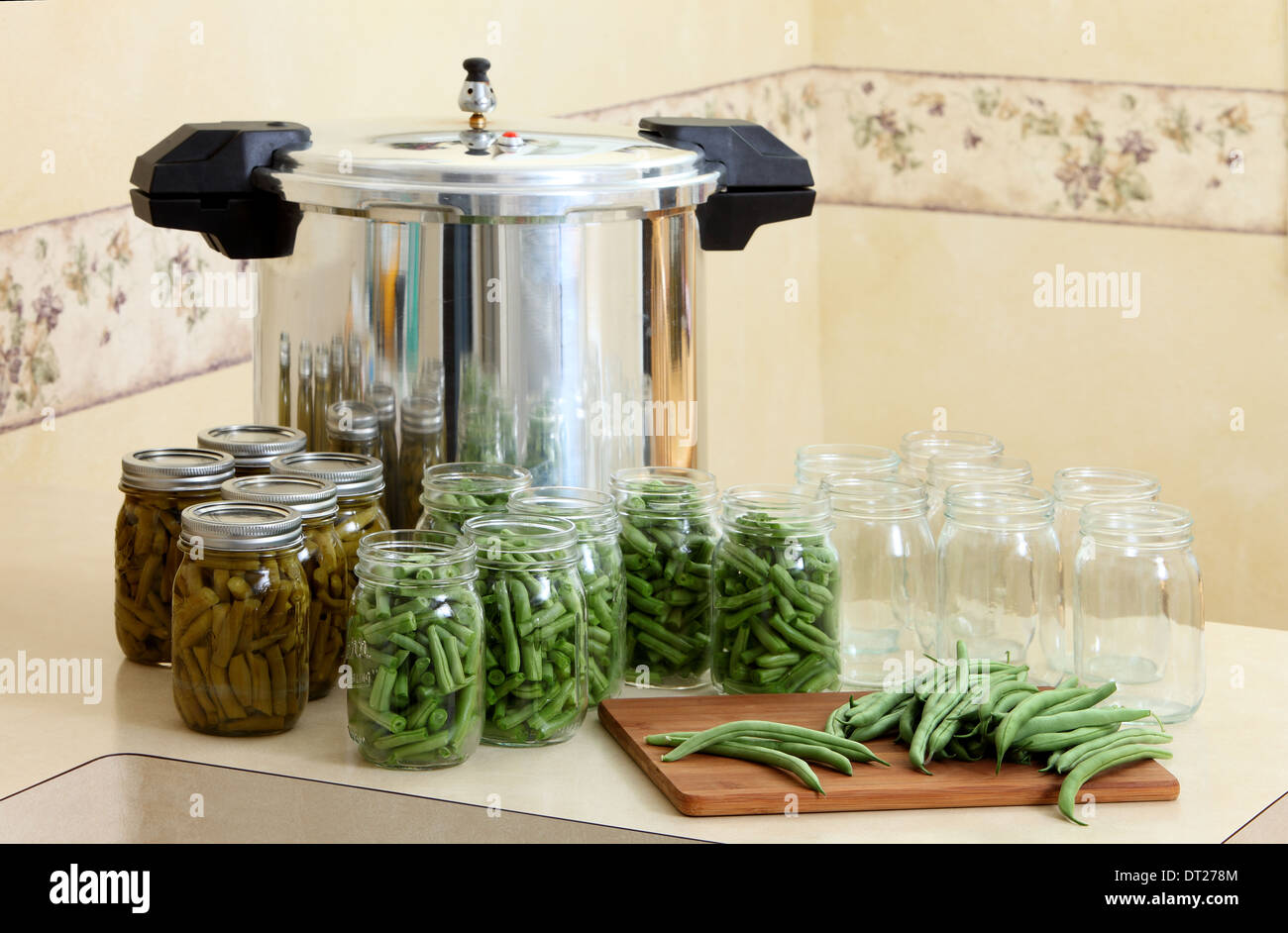 A pressure canner and bottles for preserving string beans. Stock Photo