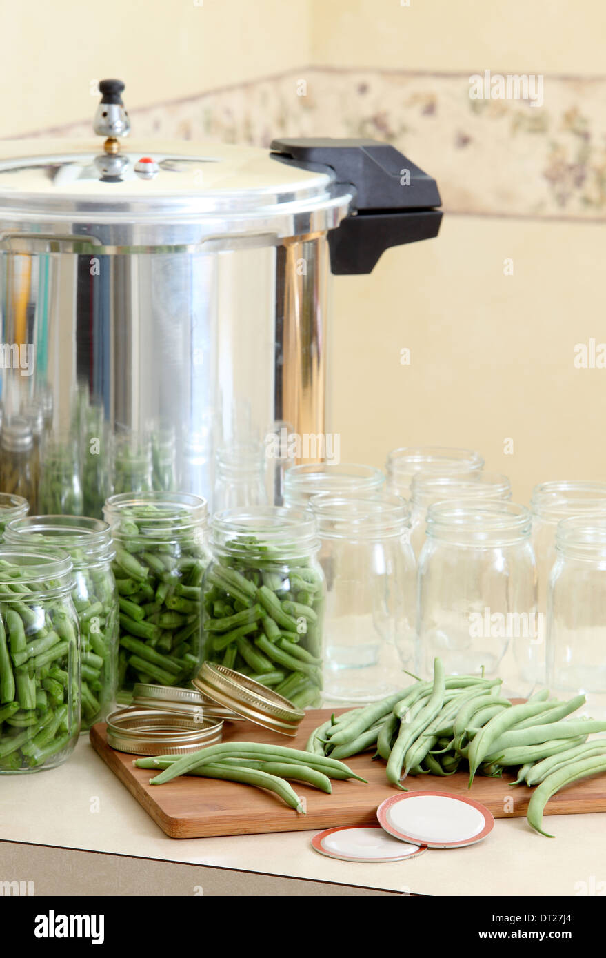 A pressure canner and bottles for preserving beans Stock Photo