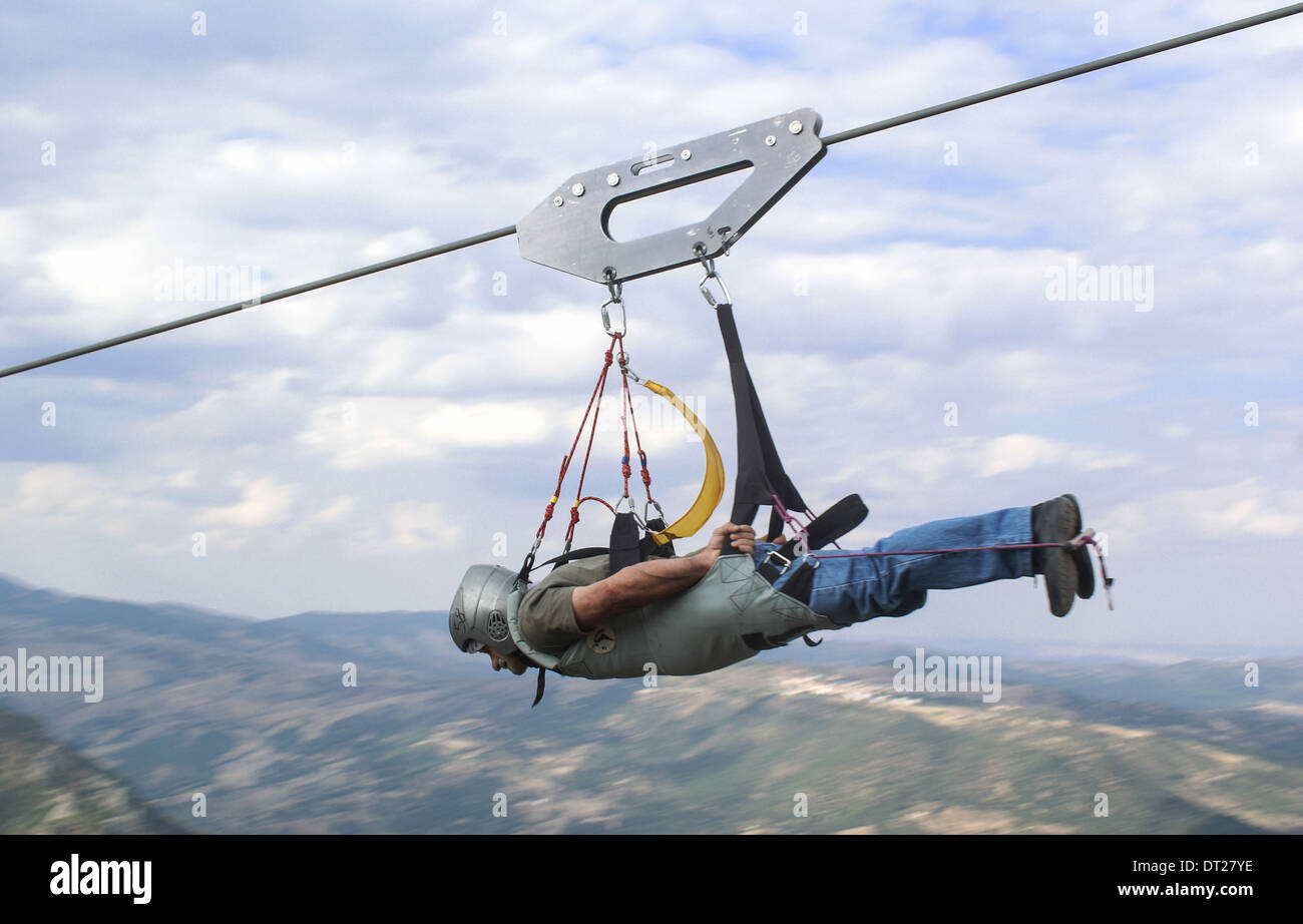 zip wire il volo del angelo   man flying on zip wire Stock Photo