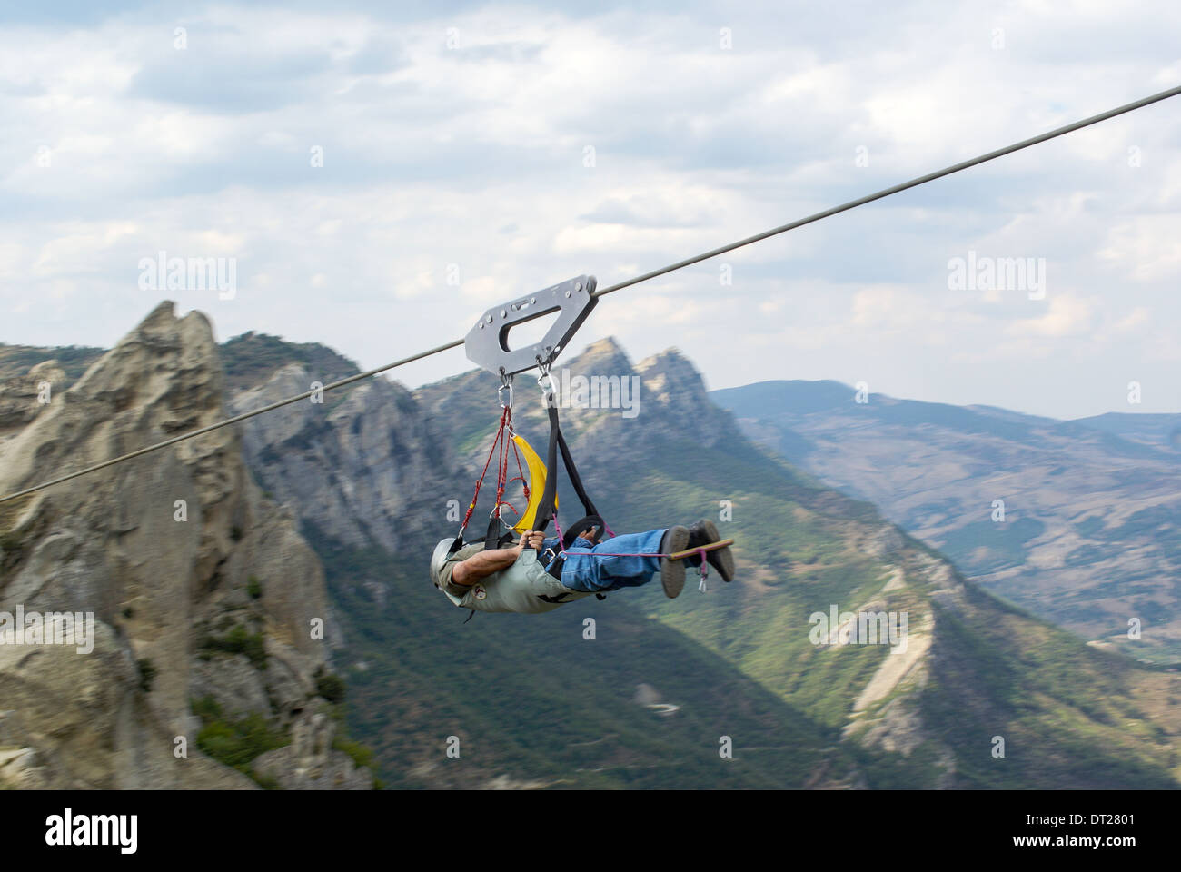 zip wire il volo del angelo   man flying on zip wire Stock Photo