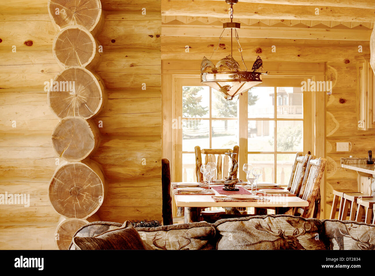 The dining room in a modern log cabin, with rustic decor, and furniture. Stock Photo