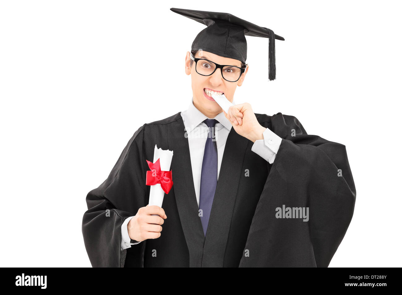 Male college graduate biting his worthless diploma Stock Photo
