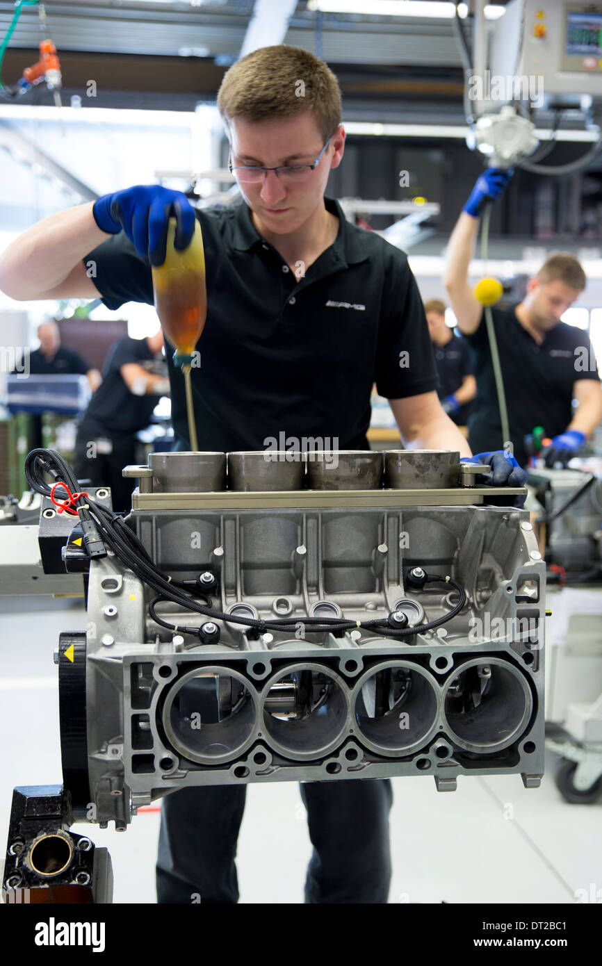 Mercedes-AMG engine production factory in Germany engineer applies lubricant oil to cylinders for pistons of 6.3 litre V8 engine Stock Photo