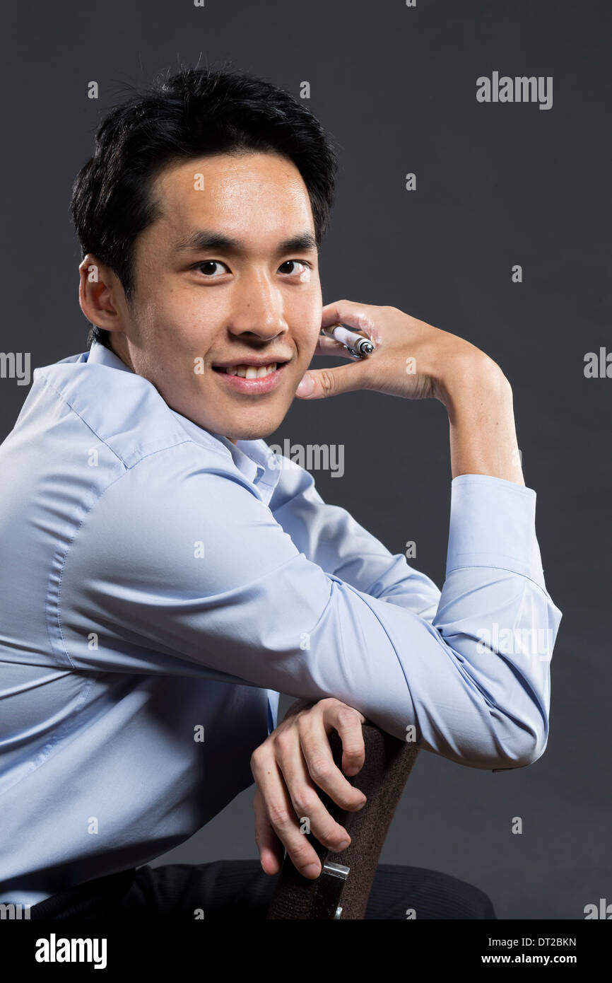 Portrait Of A Stylish Asian Business Man Dark Grey